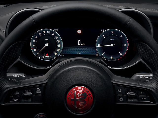 Red Alfa Romeo logo on steering wheel